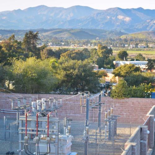 View of power plant with mountains in background