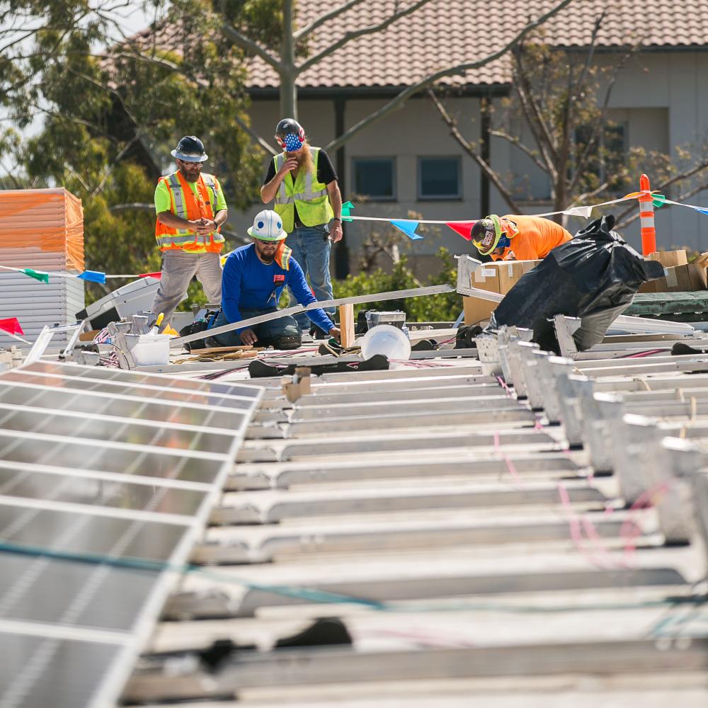people installing solar panels